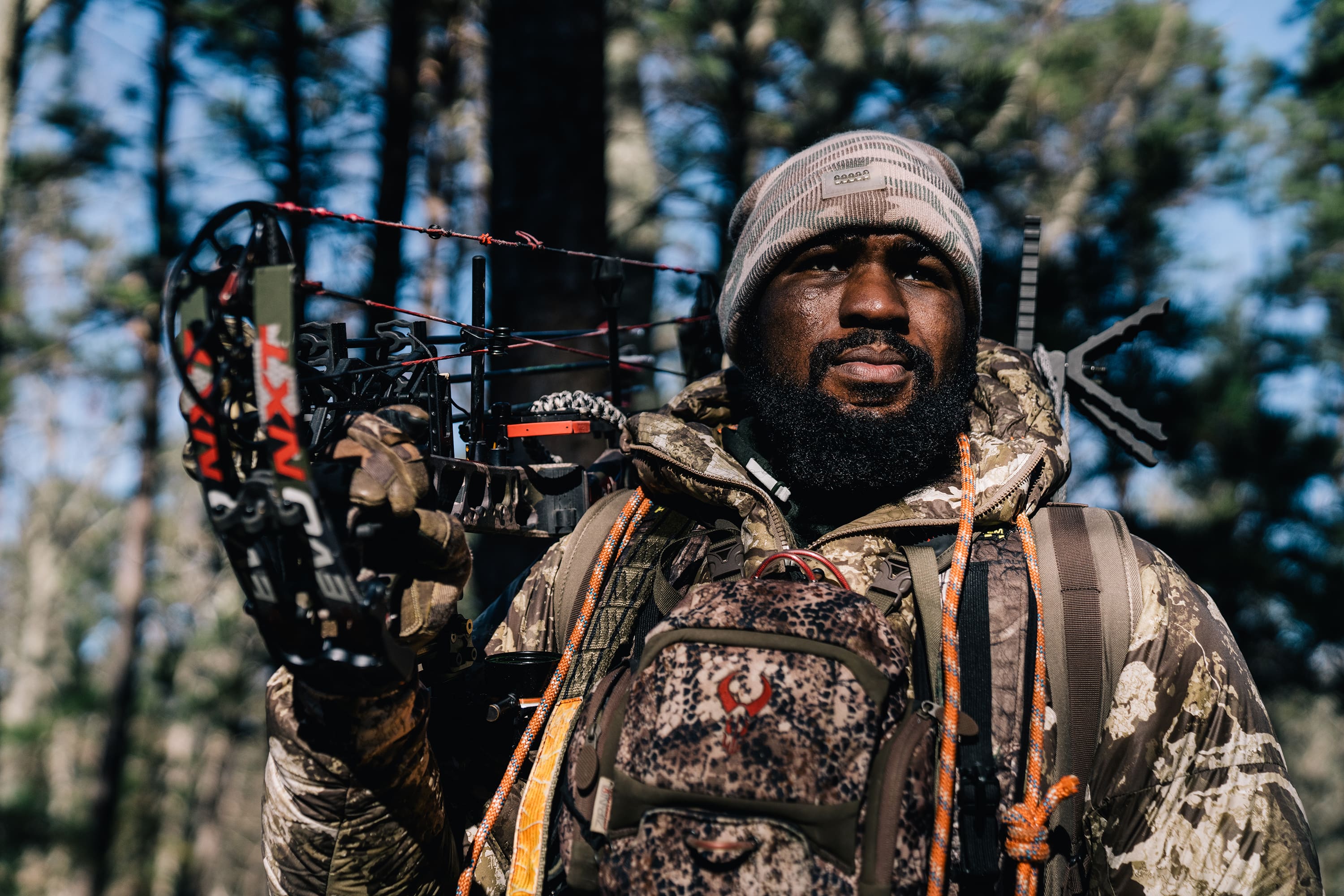 Man with hunting bow in the forest