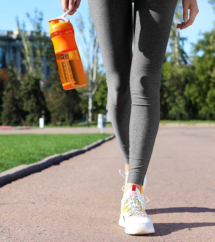 Person walking on sidewalk with reusable water bottle