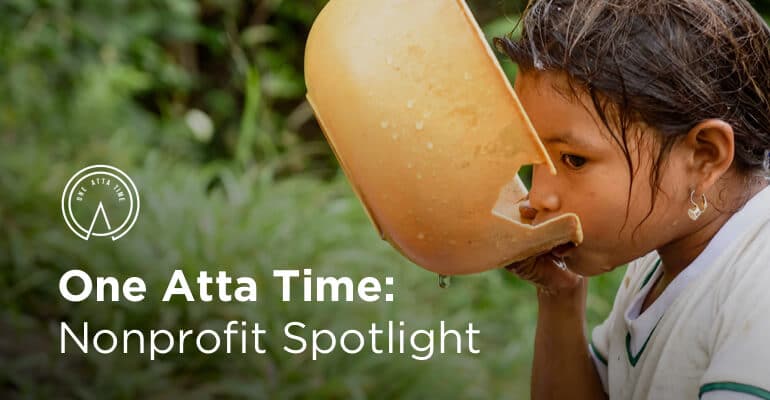 Girl drinks water from a bowl with text one atta time nonprofit spotlight