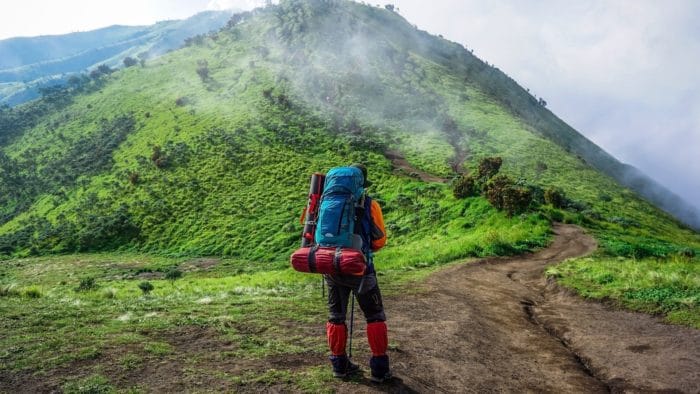 Backpacker on grassy trail