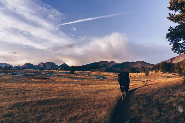 A hiker with backpack on trail in the wind river range