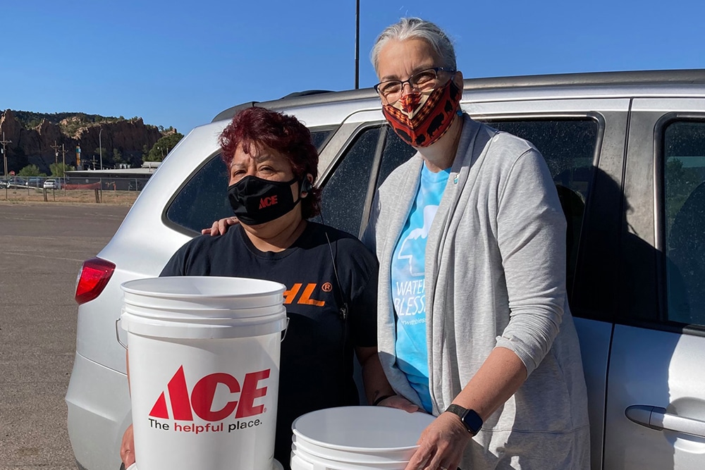 Ursuline Sister of Mount Saint Joseph Larraine Lauter, right, executive director of Water With Blessings, and a member of the Navajo Nation are seen with stacks of buckets to which Sawyer PointONE filters will be attached