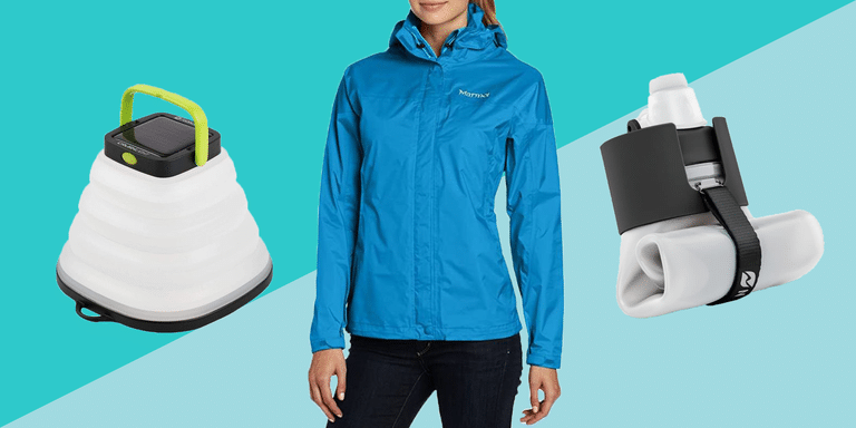 Woman wearing hiking jacket next to other gear items