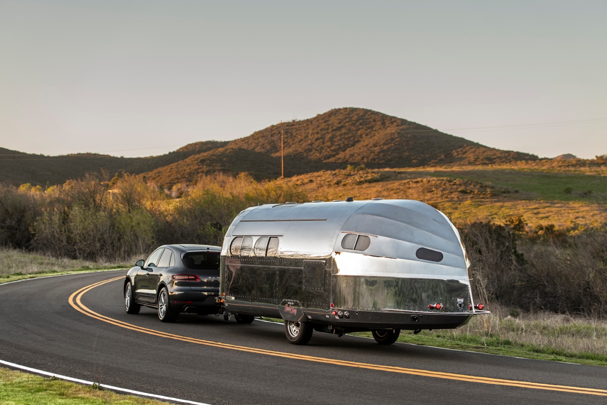 An SUV pulling a camping trailer on the highway