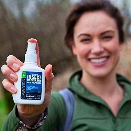 Woman holding Sawyer insect repellent