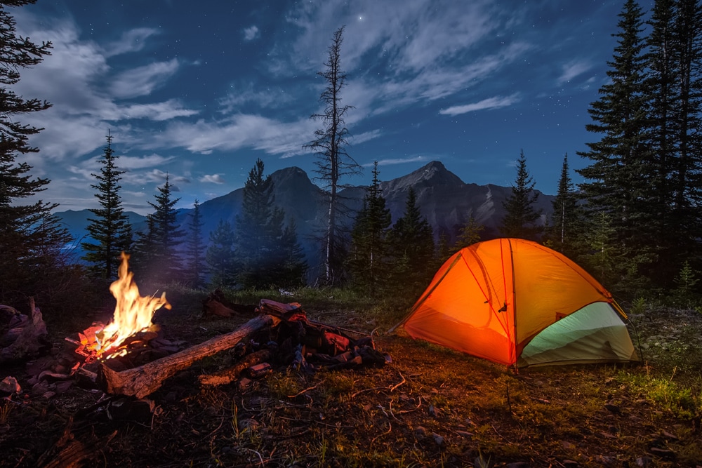 Tent next to fire nightfall