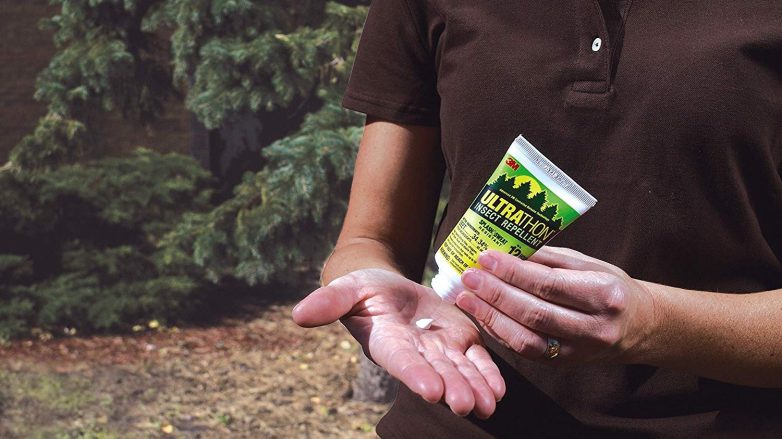 Person applying insect repellent