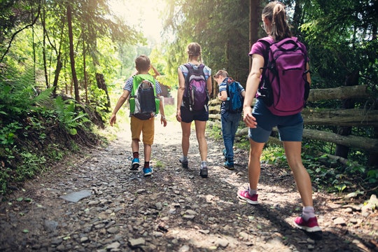 Kids with backpacks walking down trail