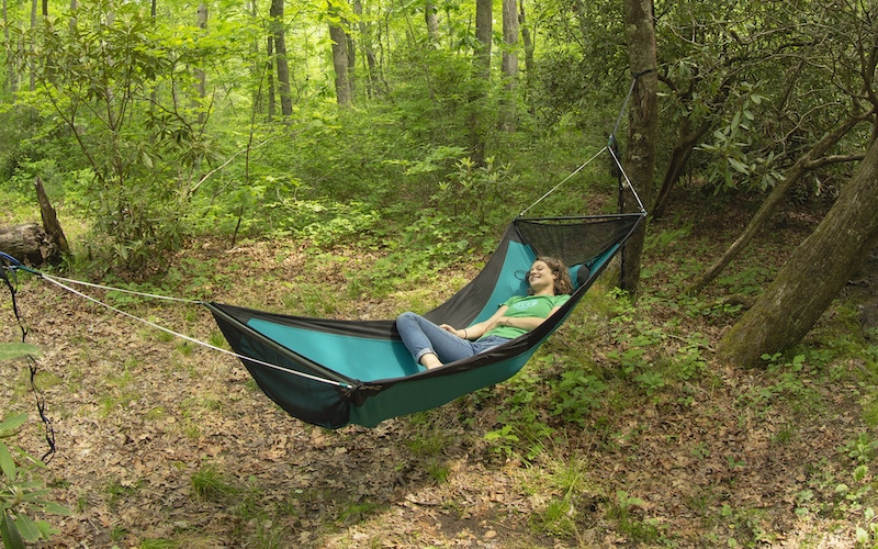 Woman in hammock in the forest