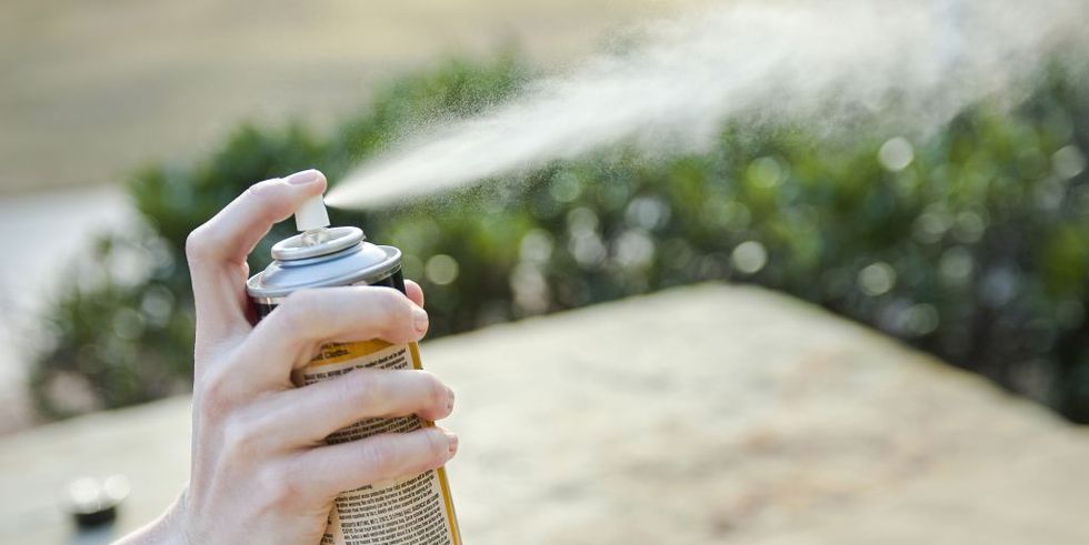 Can of insect repellent being sprayed