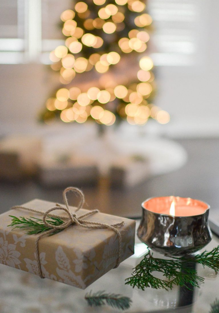 Christmas decorations and lights with a gift and candle