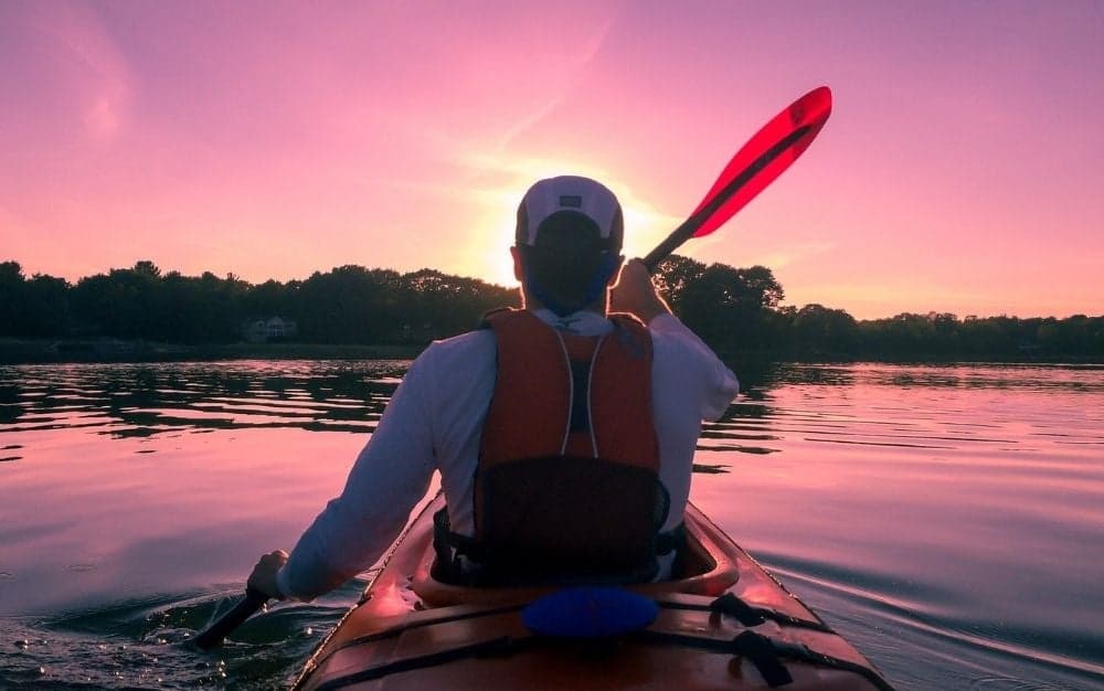 A man paddles a kayak