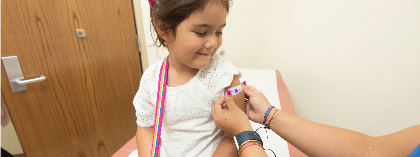 nurse puts bandaid on little girl new grad nursing skills