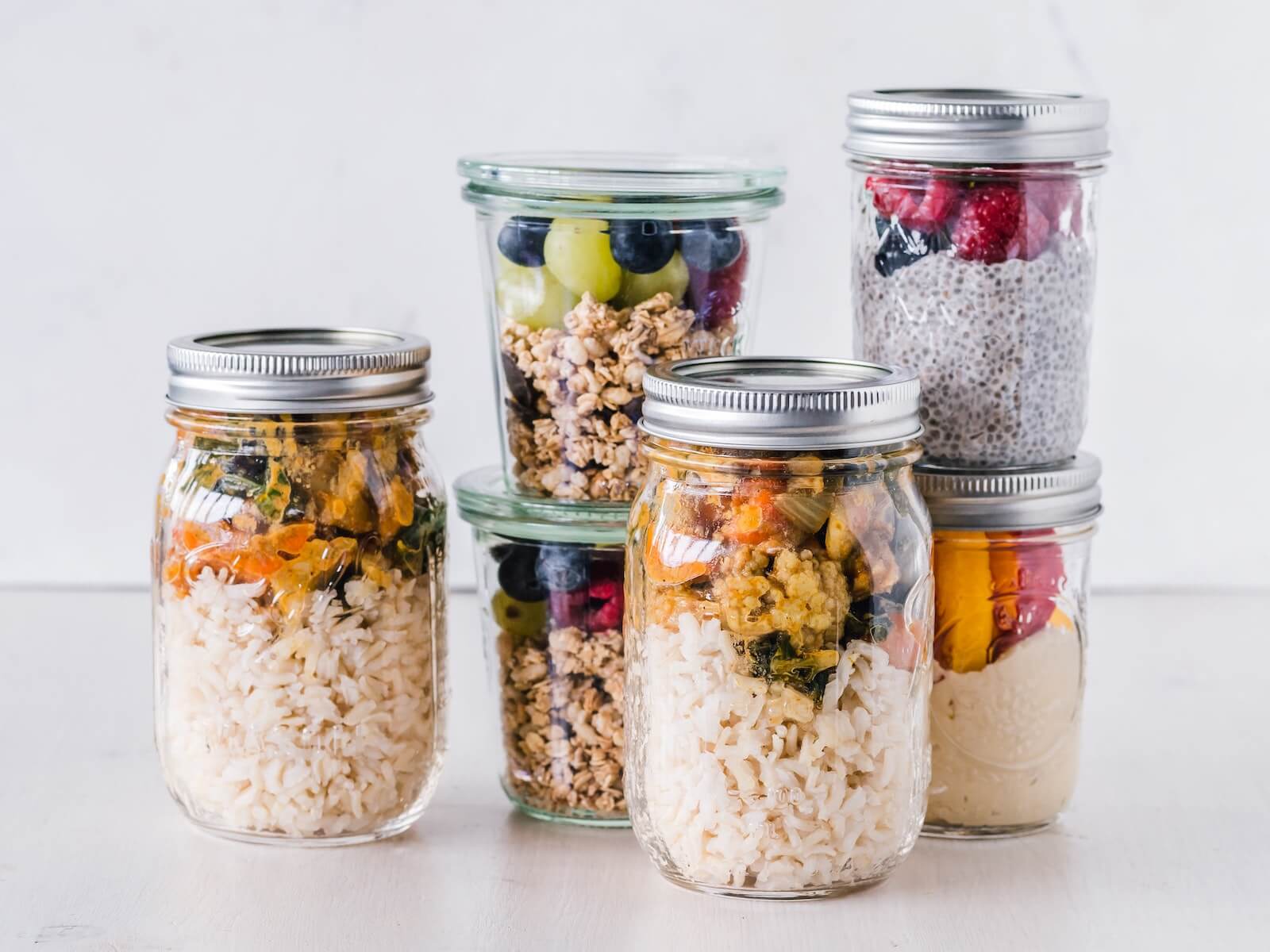 stack of mason jars with a variety of healthy snacks inside staying healthy at work as a nurse