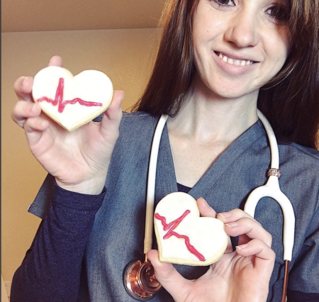 anna rodriguez rn holding up heart cookies burnout warrior