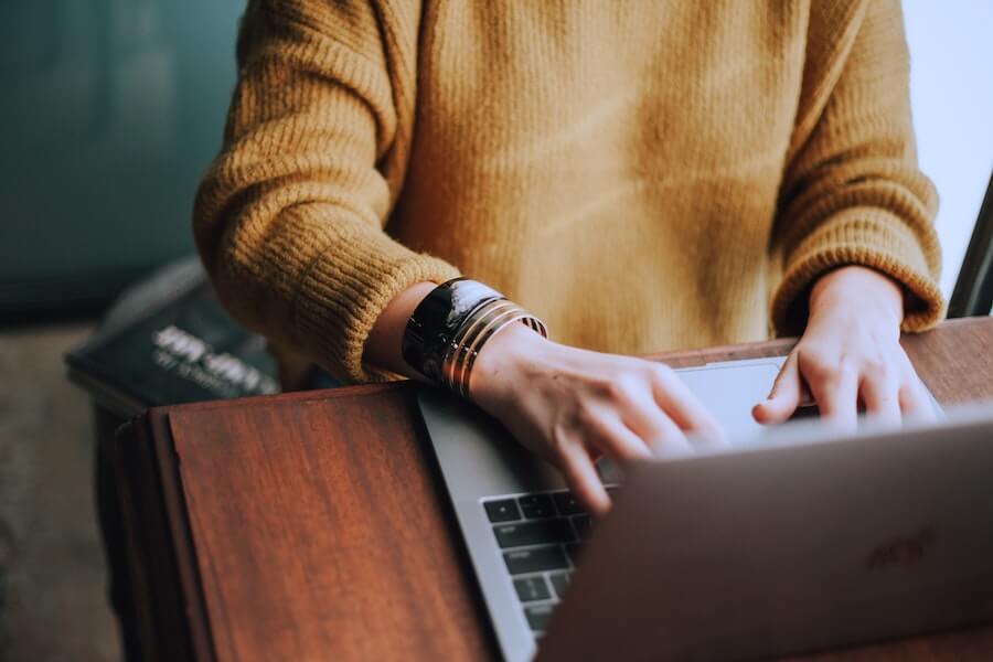 woman sitting at desk typing on computer nursing jobs skills