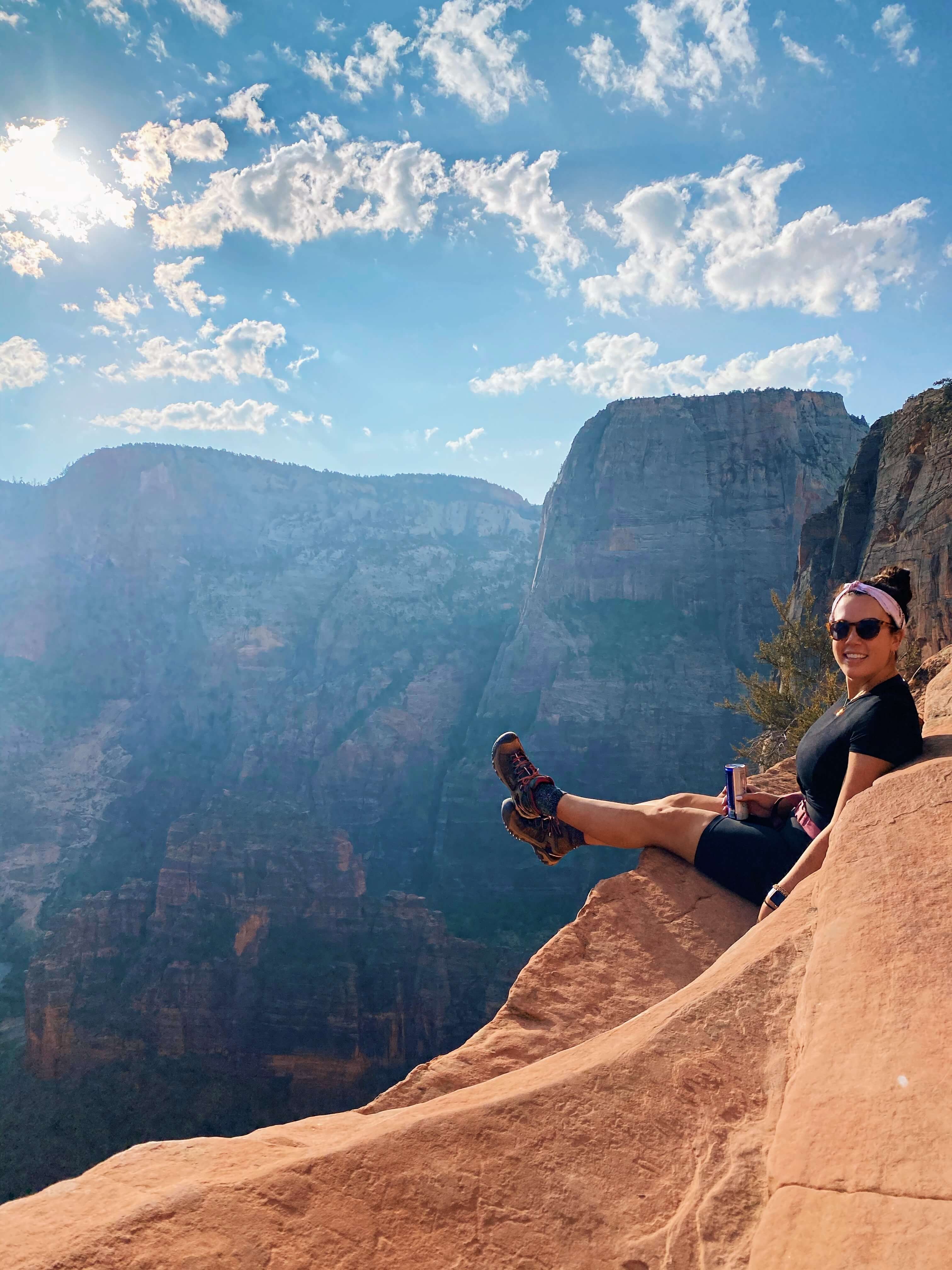 Adrea sitting on a cliff.