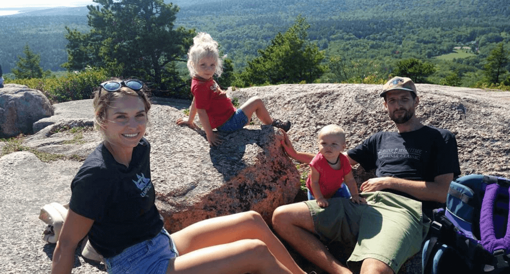 Russ mortland with family nomadic nurse on top of mountain top with nature view behind