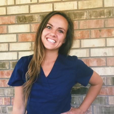 nurse leah gnitka smiling in scrubs