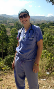 mission nurse in scrubs in front of desert trees