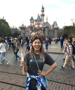 disney nurse jasmine chen standing in front of disneyland castle