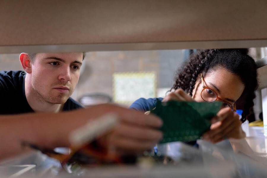 man and woman reaching for something on a shelf confidence in nursing