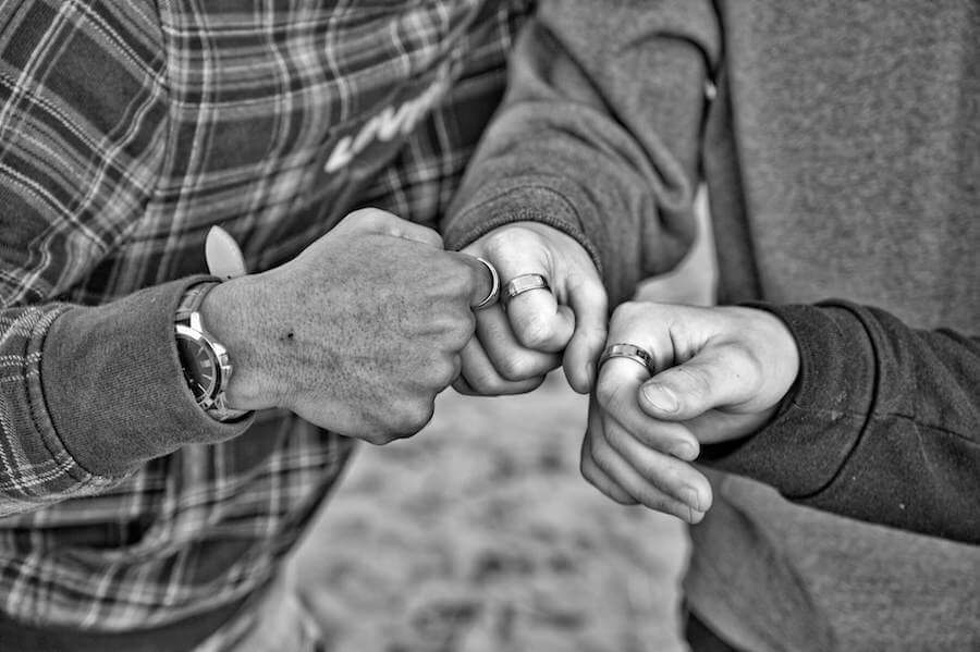 three people fist bumping closeup of hands team nursing nurse team meeting