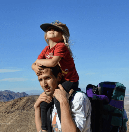 russ mortland nurse with child on back in desert