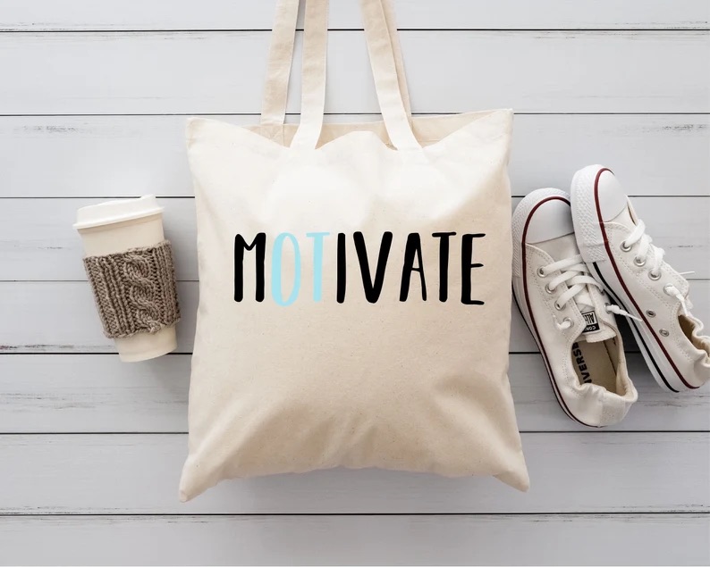 A canvas tote bag with 'MOTIVATE' prominently displayed across the front, cleverly highlighting 'OT' in a contrasting teal color. The tote is flanked by a coffee cup in a knit sleeve and classic white sneakers, symbolizing an on-the-go lifestyle perfect for an energetic occupational therapist.