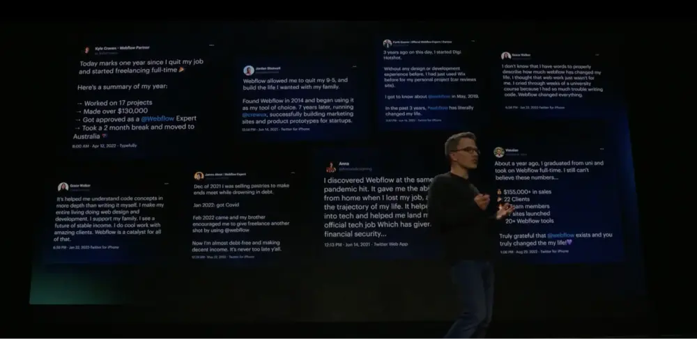 Vlad (CEO Webflow) parlant sur scène avec un micro, et des commentaires de membres de la communauté Webflow en arrière plan