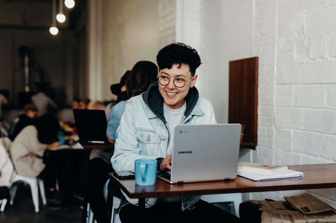 person smiling in front of computer