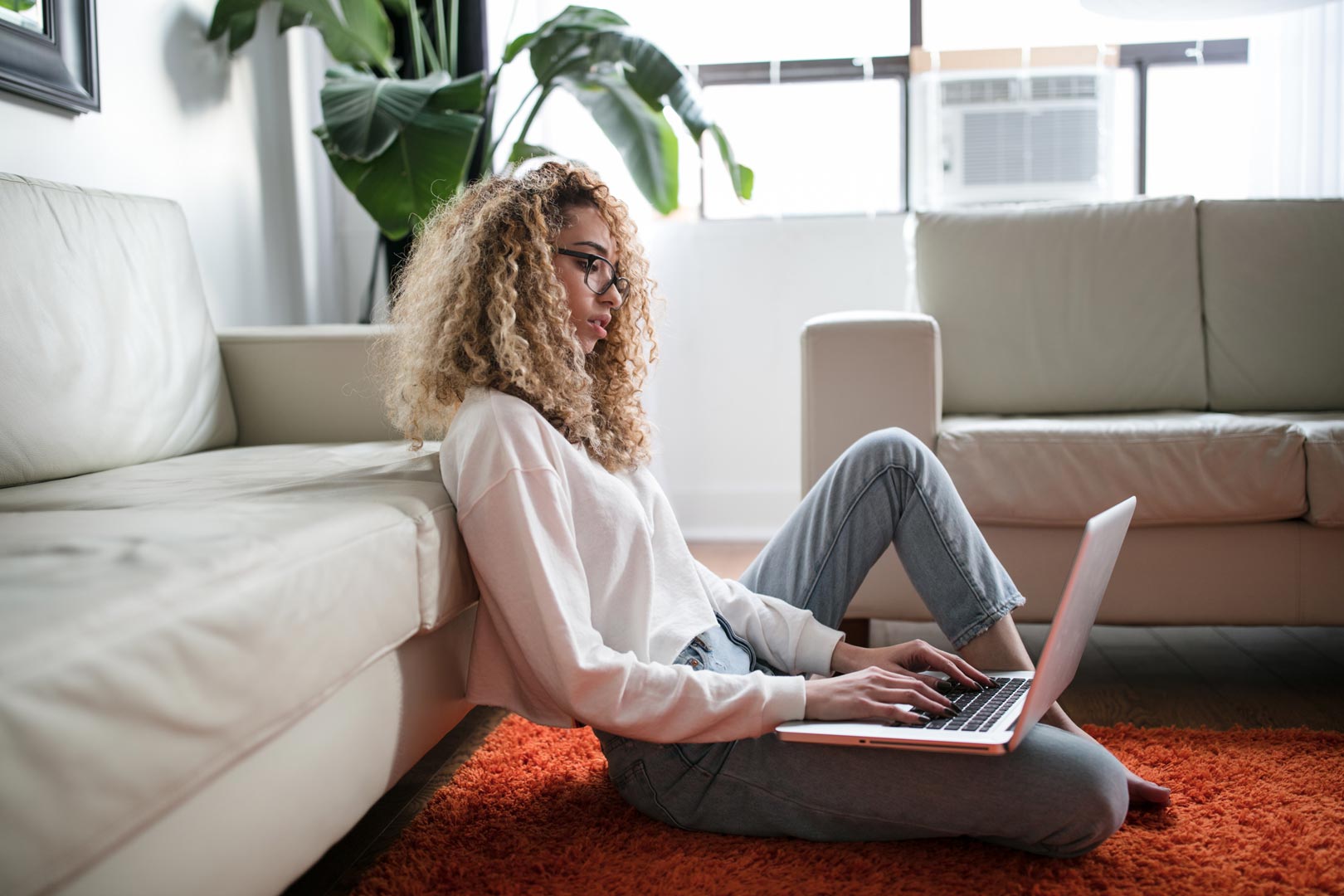 a woman works in her living room