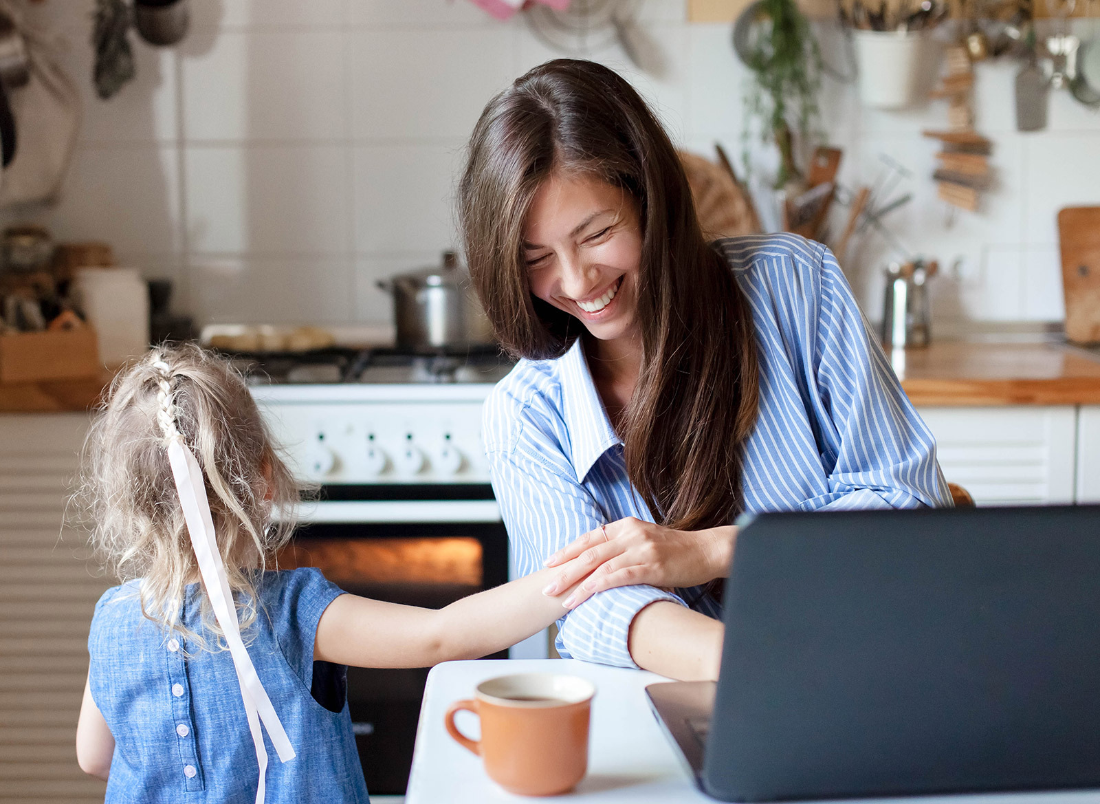 a woman laughs with child