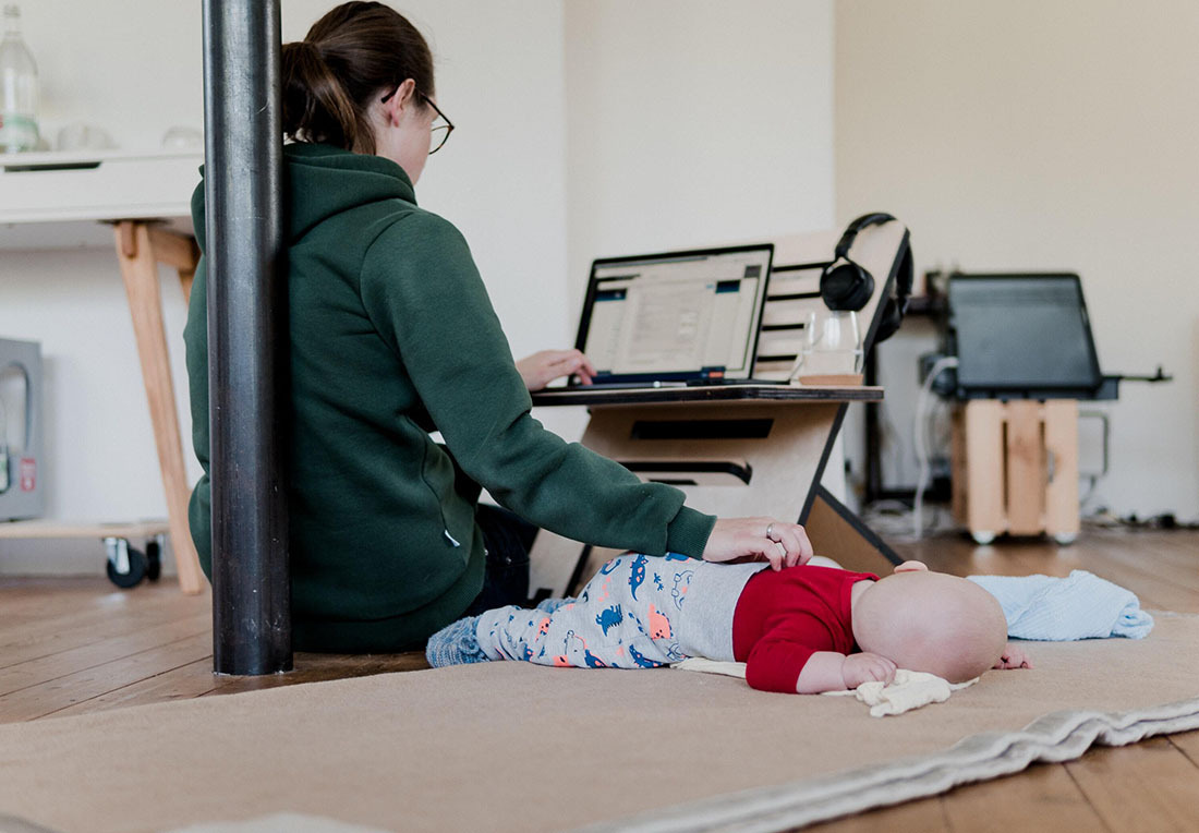 a woman works and cares for a child