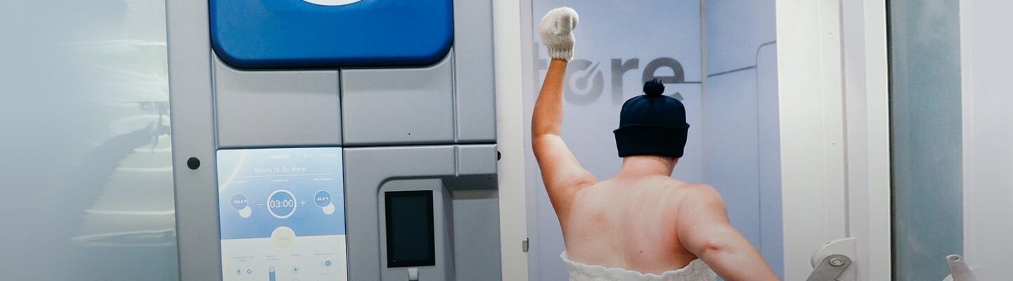 Woman entering cryotherapy machine.