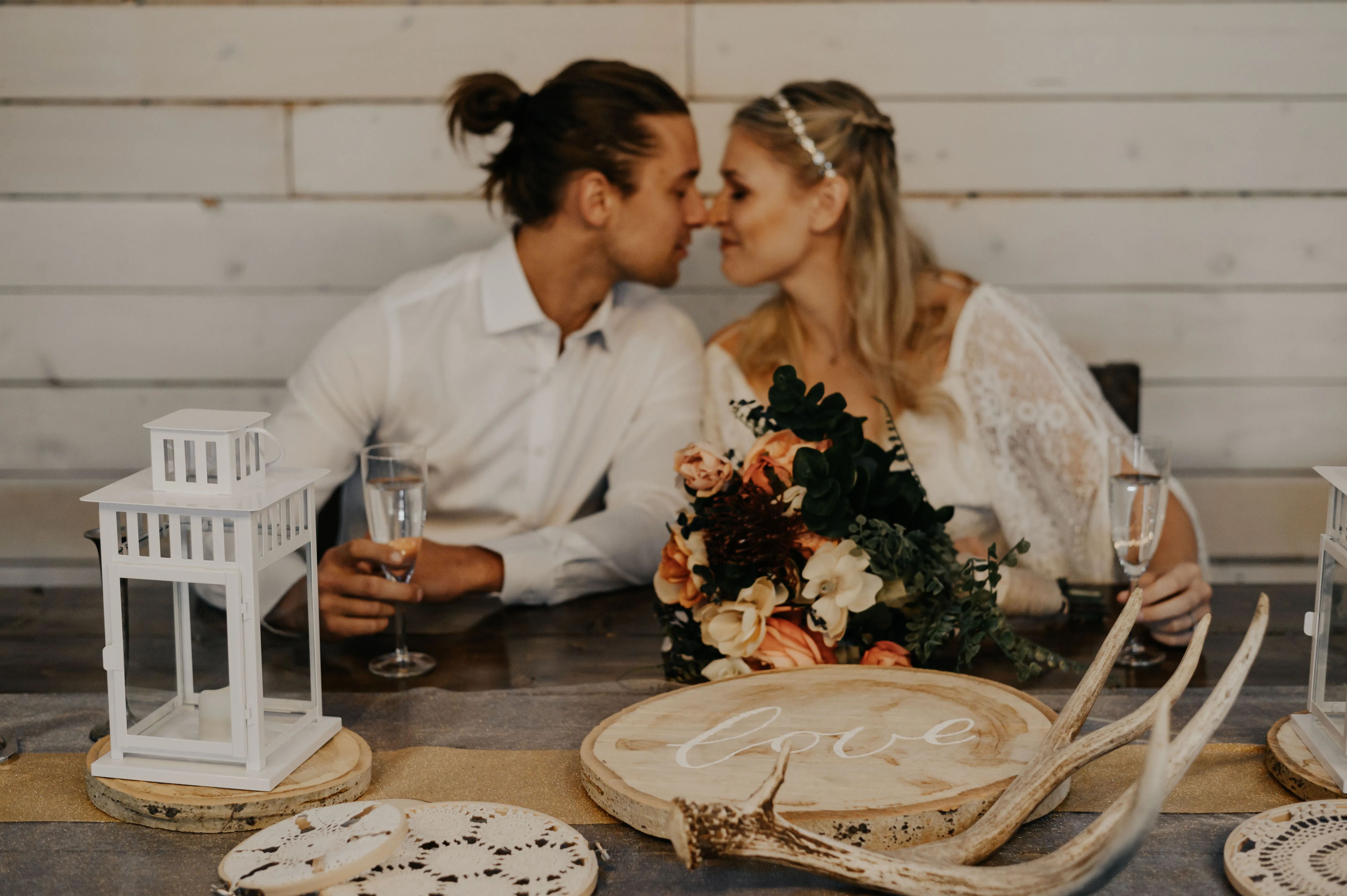 Bride and groom kissing at head table