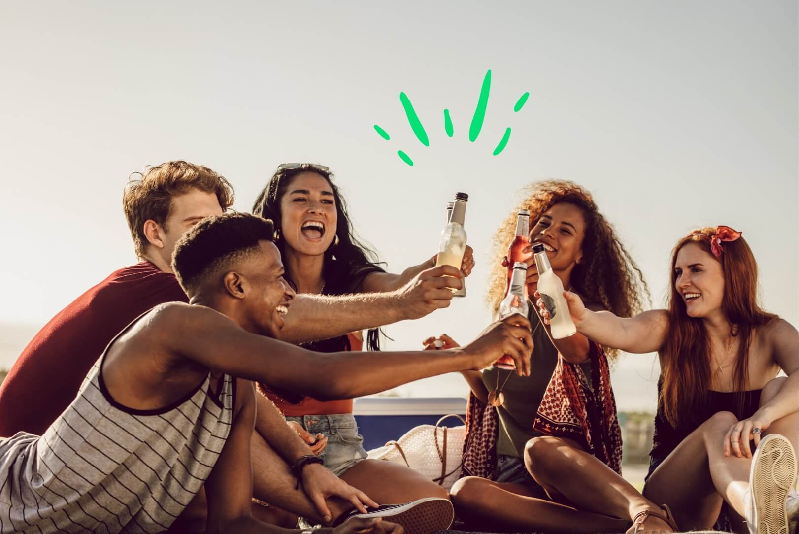 Friends on a beach celebrating a vacation on a budget.