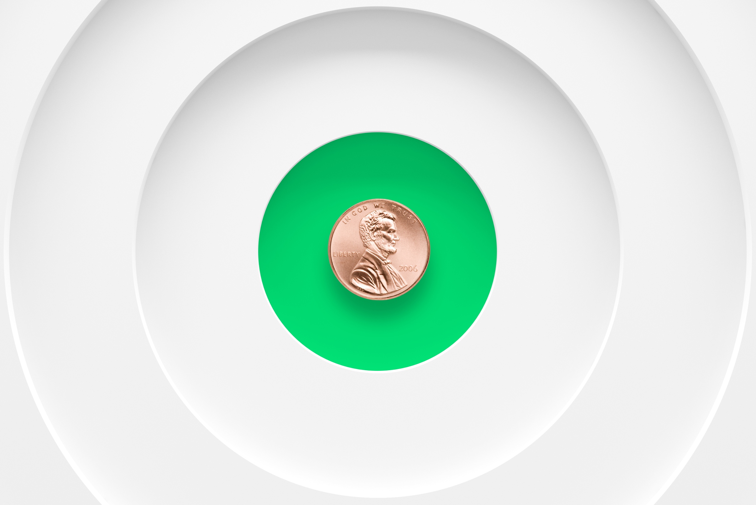 Person holding two pennies between their fingers to show how to invest with small amounts of money.