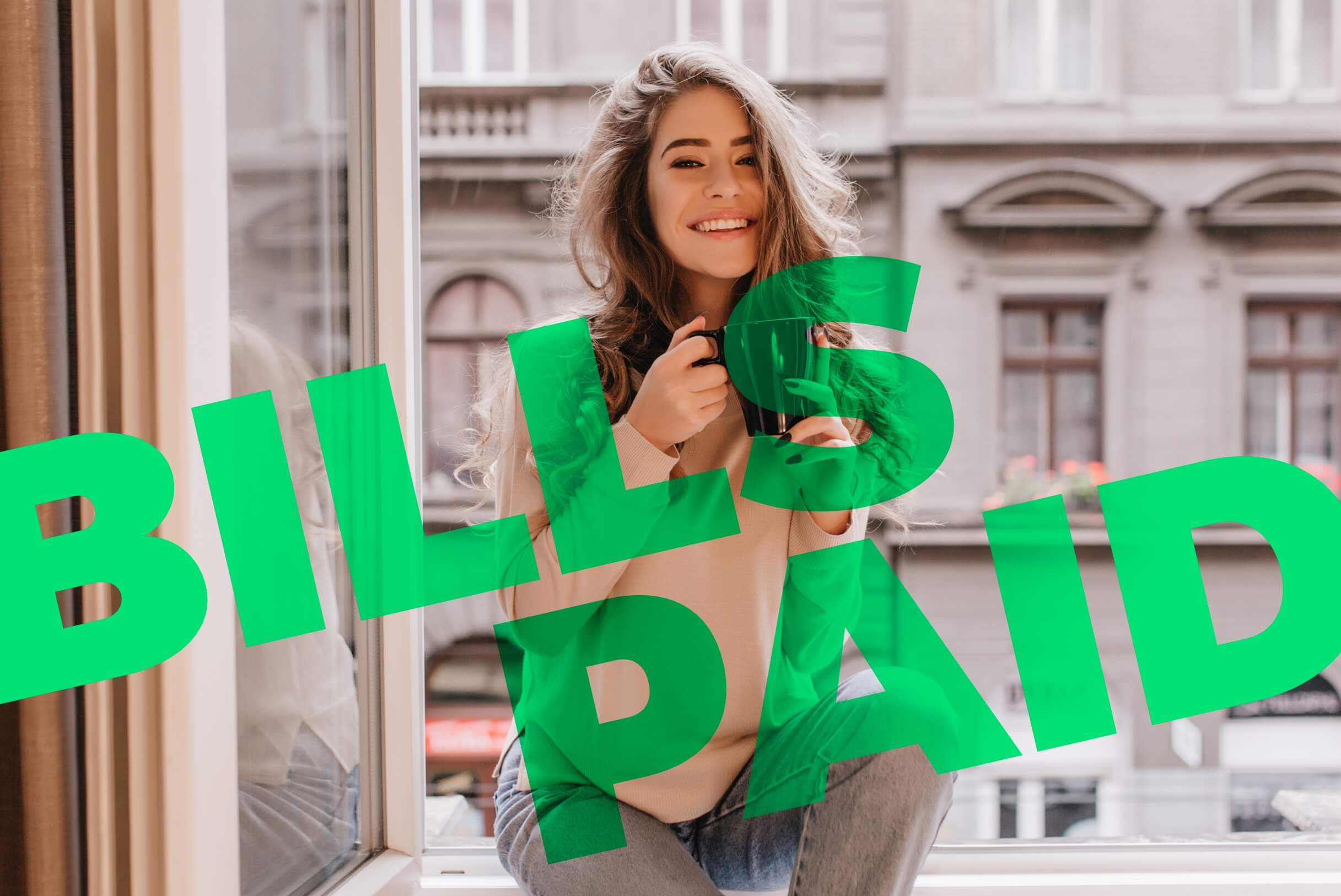 Woman sitting with a mug, smiling because her bills are paid and she is ready to teach you howe to pay your bills