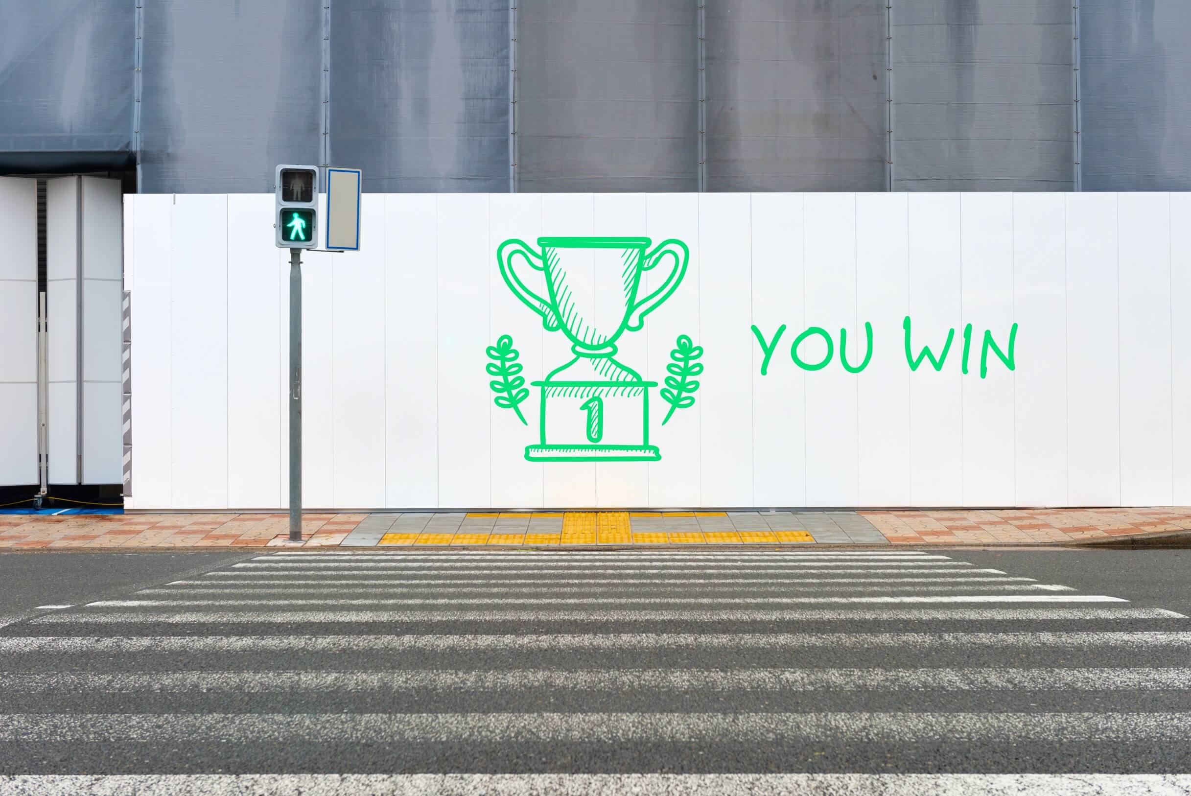 Green trophy painted on a white banner with the words you win, referencing success for meeting financial goals for young adults