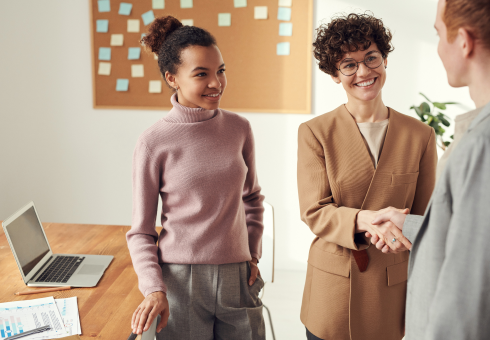 customers and brand's launch manager shaking hands