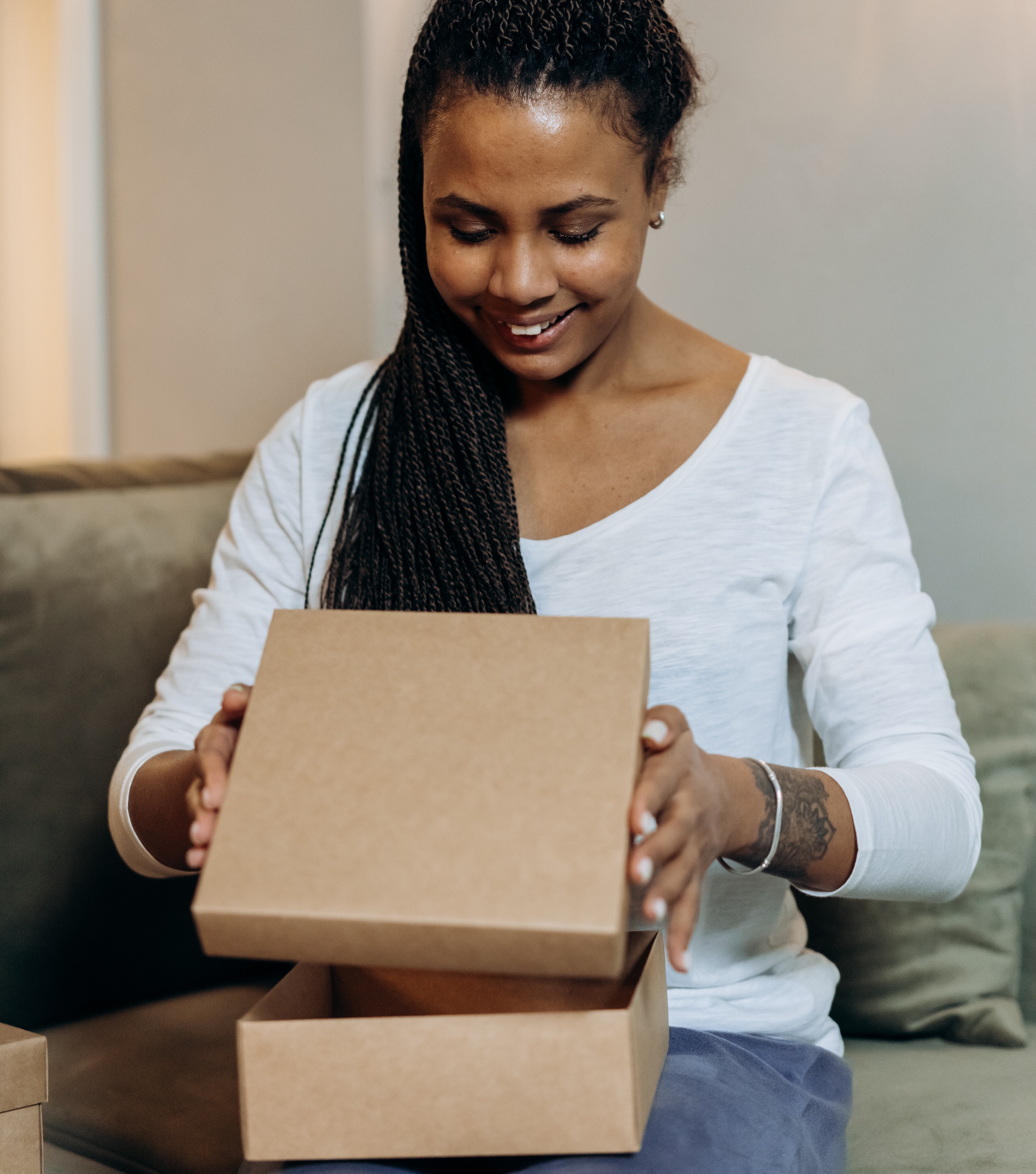 image of a woman opening a delivery box looking excited