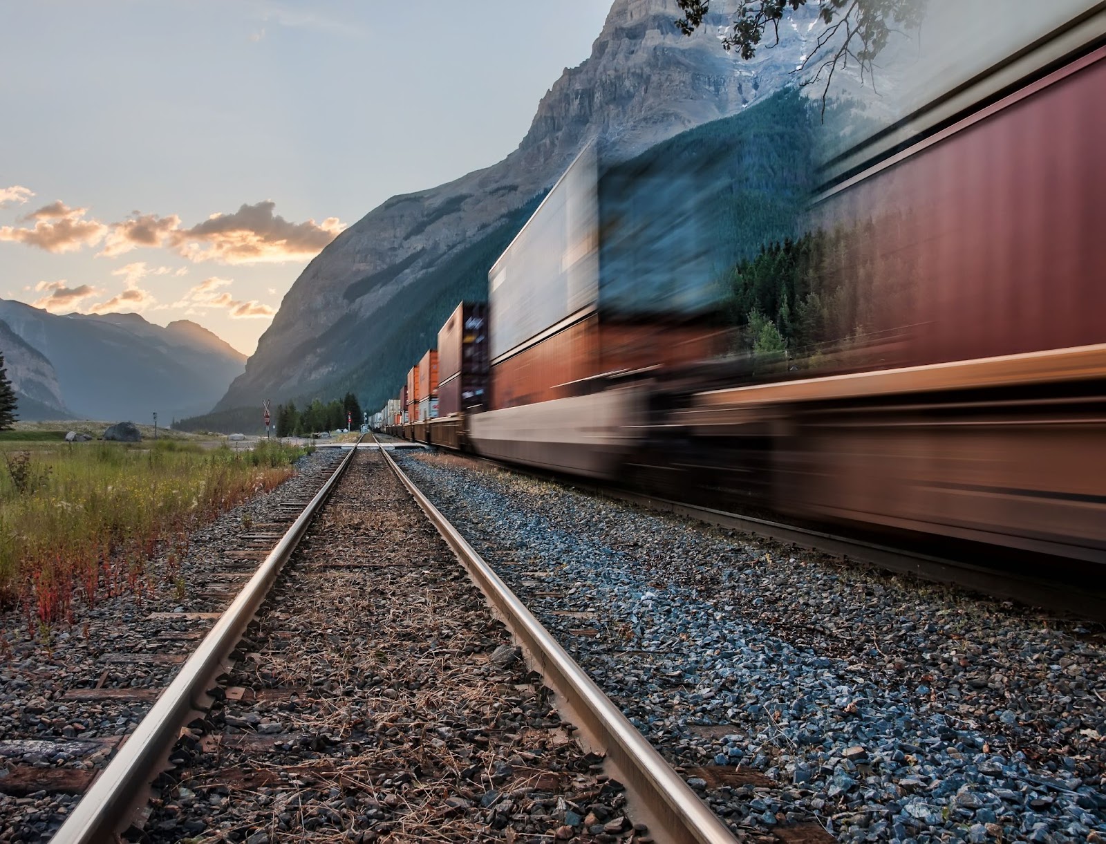 image of rail freight moving quickly through the countryside