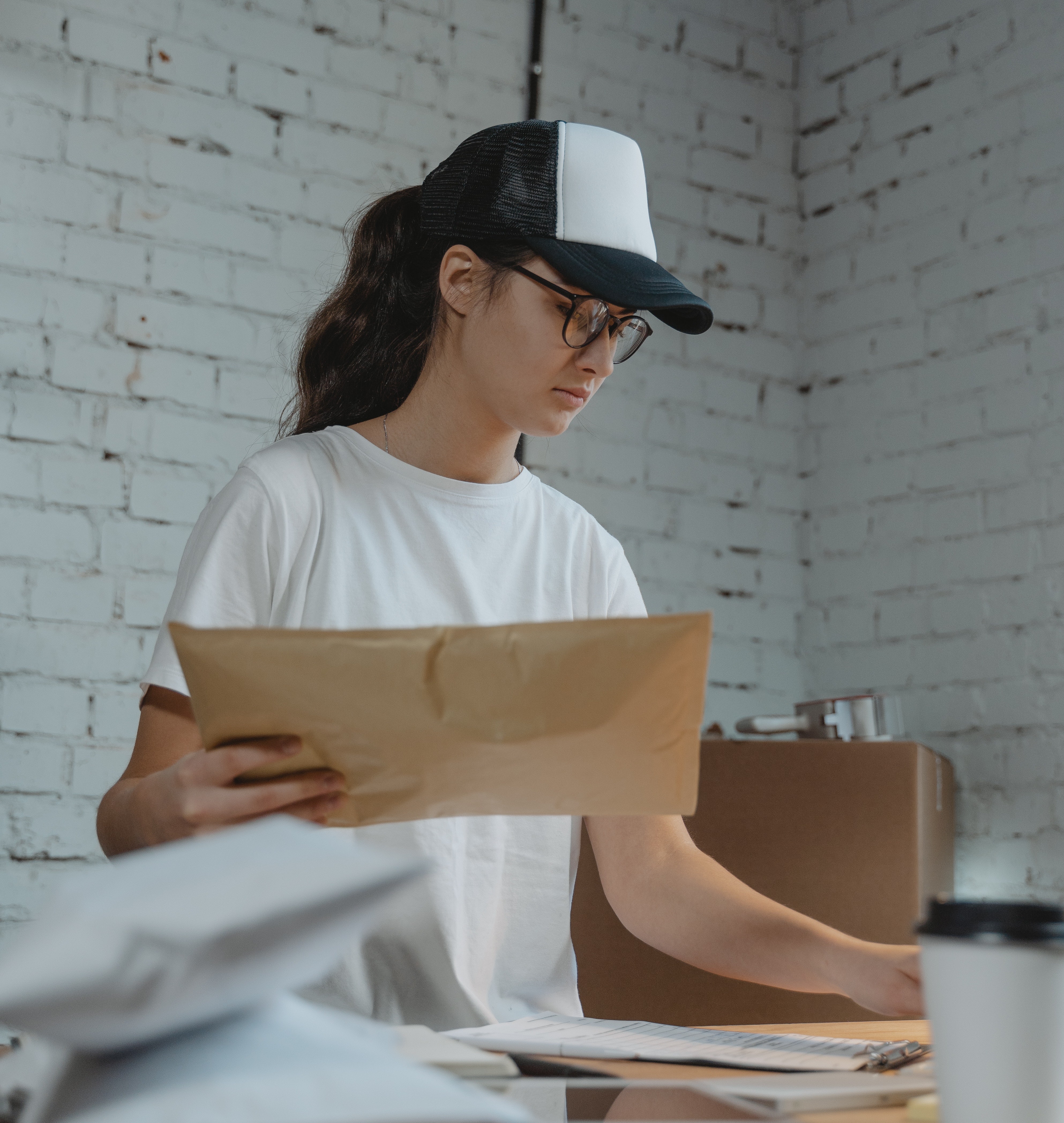Image of a woman adding a CN22 or CN23 customs declaration to her package