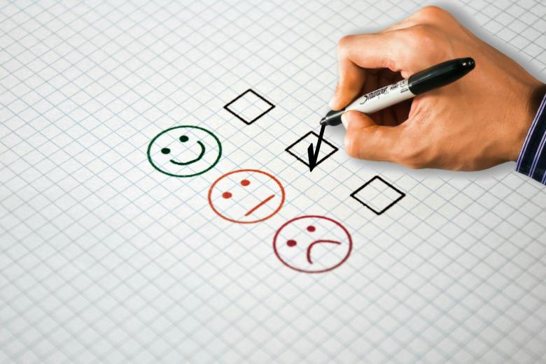 three emoticons (happy, neutral and sad) with a check box against each one.