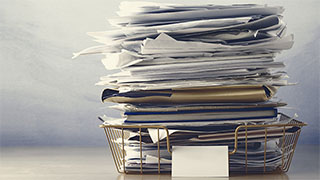 Large stack of files on a desk
