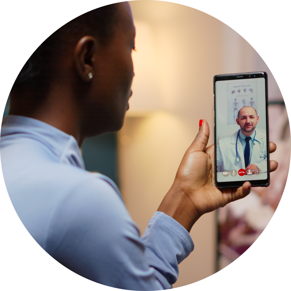 Woman holding a smartphone doing a telehealth visit with a doctor
