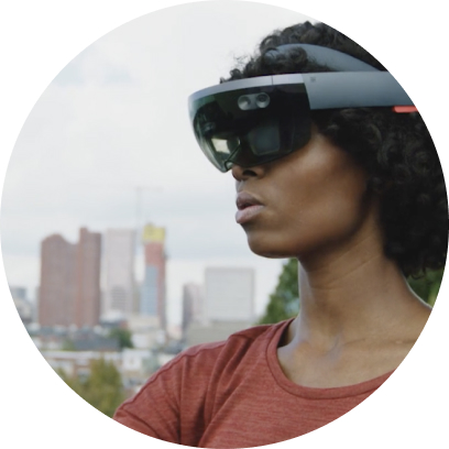 Woman standing outside wearing a VR headset with buildings and skyscrapers in background