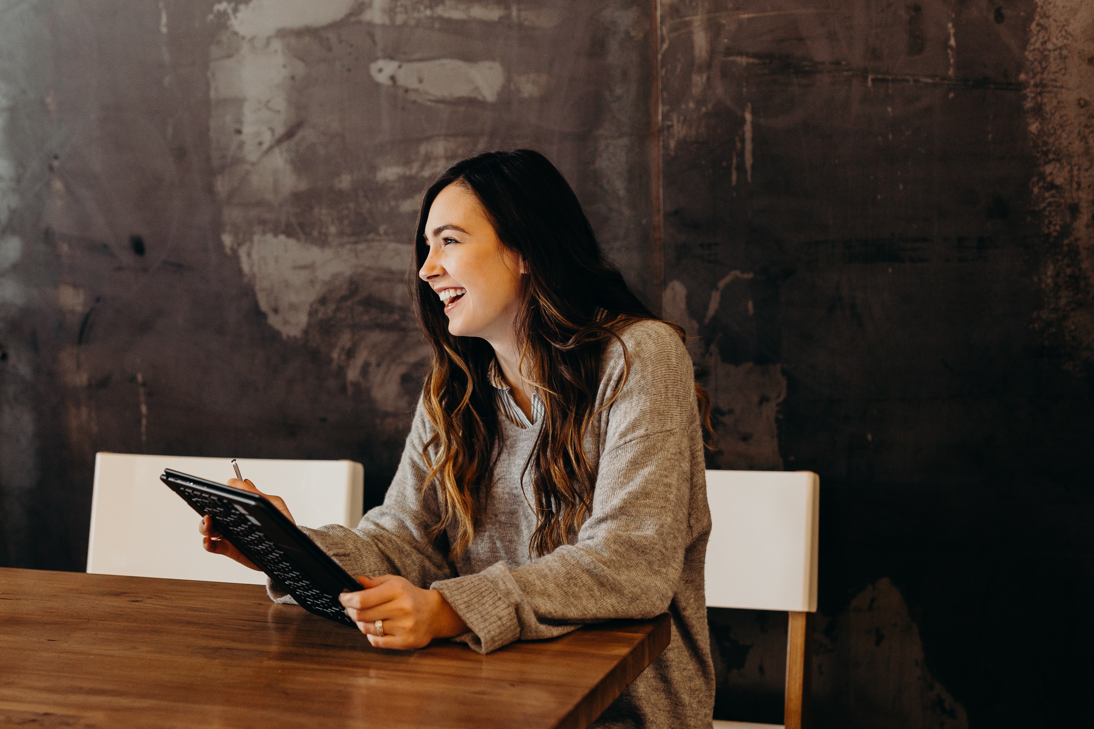 Smiling woman sitting with tablet
