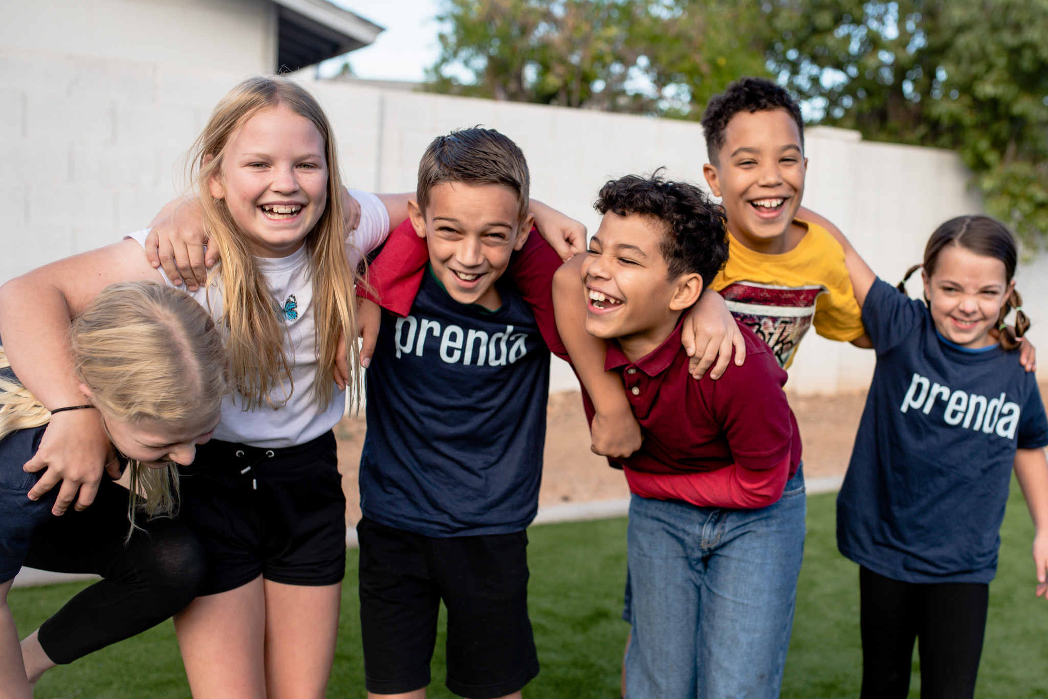 microschool students laughing with arms around each other's shoulders